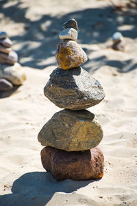 Stack of pebbles on sand at beach