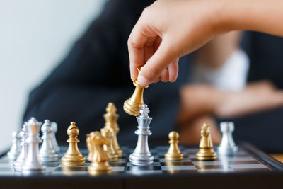 Close-up of man playing with chess