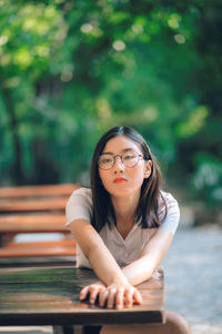 Portrait of young woman sitting outdoors