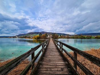 Pier over lake against sky