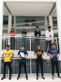 Portrait of people standing against window