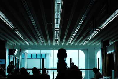 Silhouette people photographing at airport