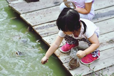 High angle view of women sitting in water