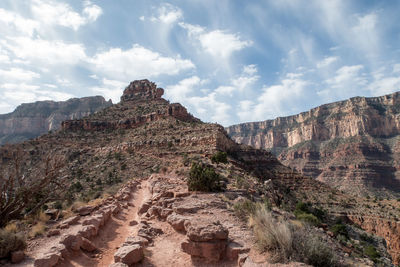 Rock formations on landscape against sky