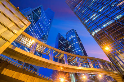 Low angle view of illuminated buildings against sky at night