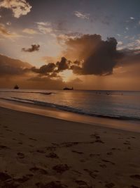 Scenic view of beach against sky during sunset