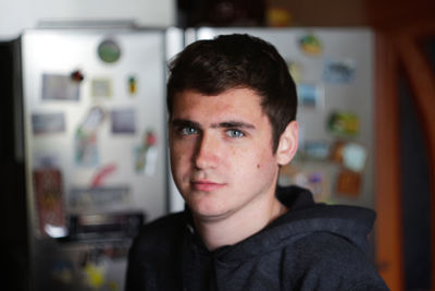 Portrait young man indoors background. serious young man with blue eyes. 20s years. handsome man 