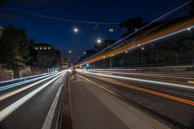 Light trails on railroad tracks at night