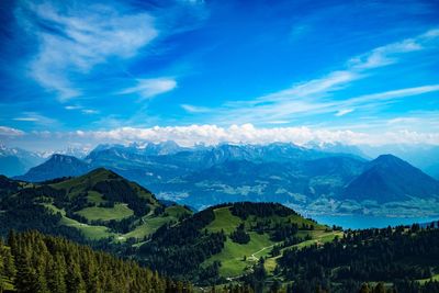 Scenic view of mountains against blue sky