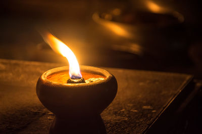 Close-up of diya burning in dark