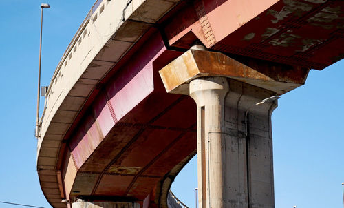 Low angle view of bridge against clear blue sky