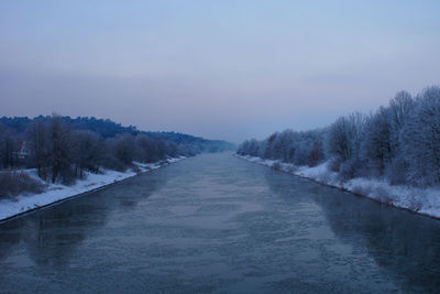 Scenic view of frozen canal against sky during winter