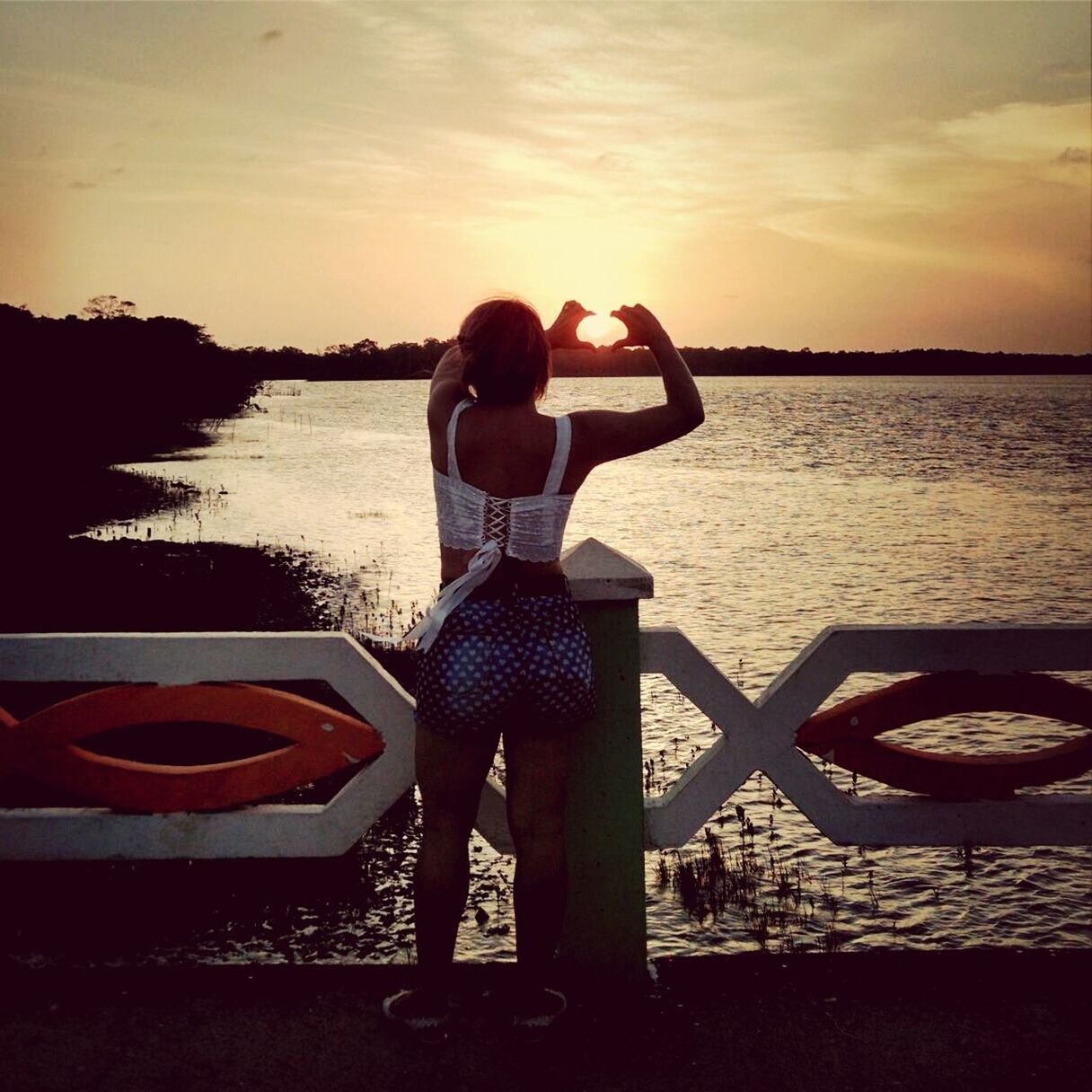 water, sunset, sea, sky, silhouette, standing, lifestyles, leisure activity, tranquil scene, rear view, tranquility, scenics, horizon over water, beauty in nature, nature, idyllic, full length, orange color