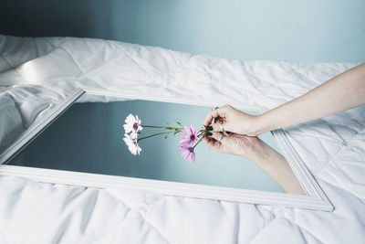 High angle view of woman relaxing on bed