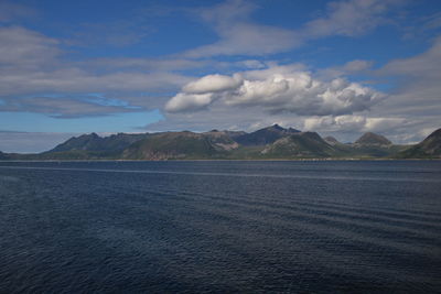 Scenic view of sea and mountains against sky