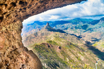 Landscape view from above of mountain range, valley and road at canary island