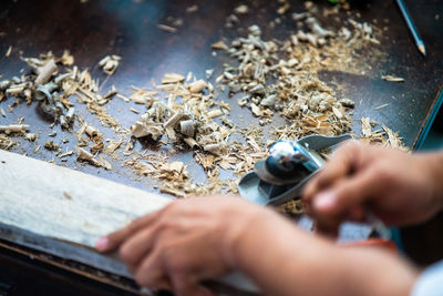 Cropped hands of person working with wood