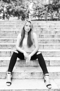 Portrait of a young woman sitting outdoors