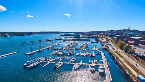 High angle view of city by sea against sky