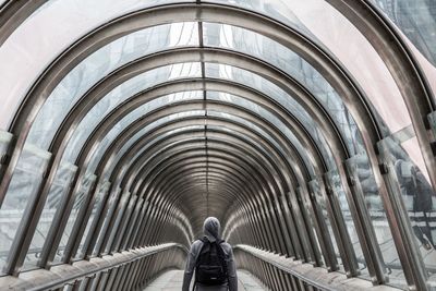 Rear view of man walking in corridor