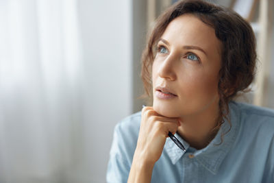 Close-up of young woman looking away