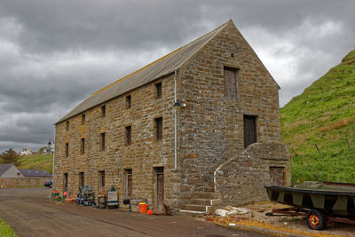 Building by street against sky