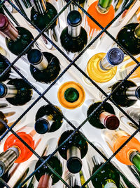 High angle view of multi colored bottles on table