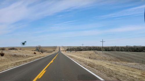 Empty country road against sky