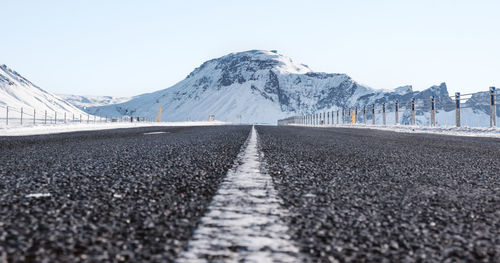 Surface level of road leaning towards mountain