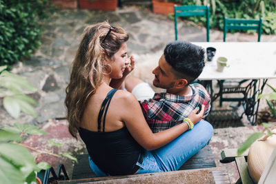 Affectionate couple sitting in backyard