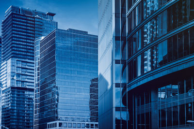 Low angle view of modern buildings against sky at dusk