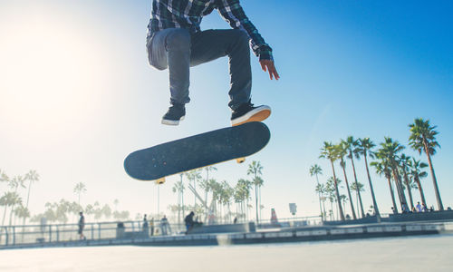 Low section of man skateboarding