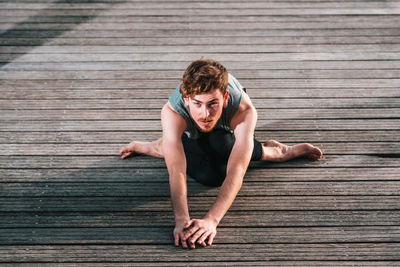 Portrait of young man relaxing on pier