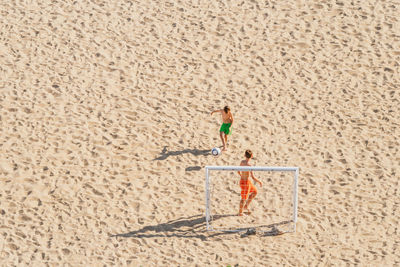 Full length of a boy with umbrella on beach