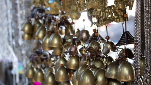 Close-up of wind chimes hanging for sale at store 