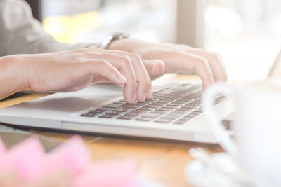 Businesswoman using laptop on table at office