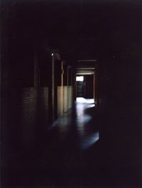 Empty corridor of illuminated building