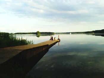 Scenic view of lake against cloudy sky