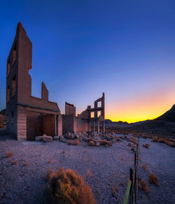 Old building against clear sky during sunset