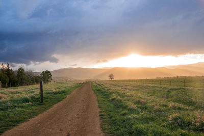 Scenic view of road against sky during sunset