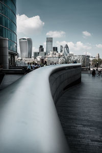Bridge over river against cloudy sky