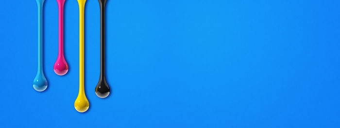 Close-up of multi colored lights against blue wall