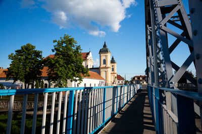 View of footbridge against cloudy sky