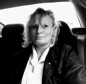 Close-up portrait of young woman in car