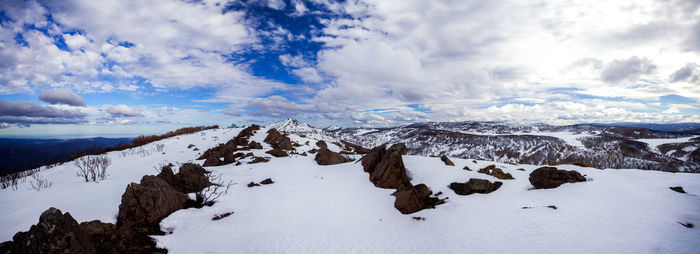 Scenic view of snow covered mountains against sky