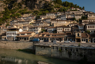 Buildings by river in town