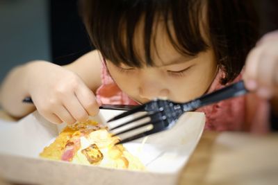 Portrait of child girl eating food