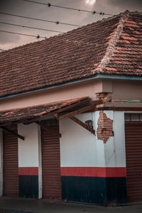 Low angle view of house roof against sky