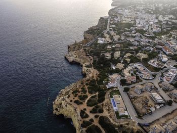 High angle view of buildings and sea in town