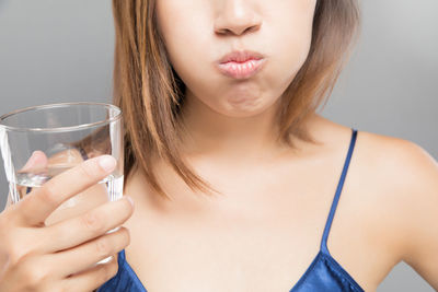 Close-up of beautiful woman holding eyeglasses